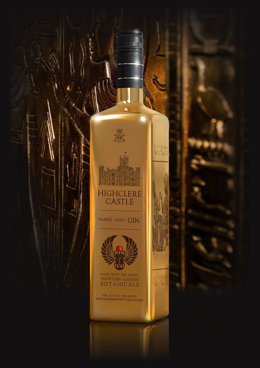 Highclere Castle Barrel Aged Gin in a gold bottle, featuring botanicals from Highclere Castle, the real Downton Abbey, set against an intricate and luxurious background.